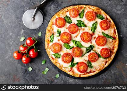 Pizza Margherita with mozzarella cheese, basil and tomatoes Traditional italian food. Classic recipe. Top view
