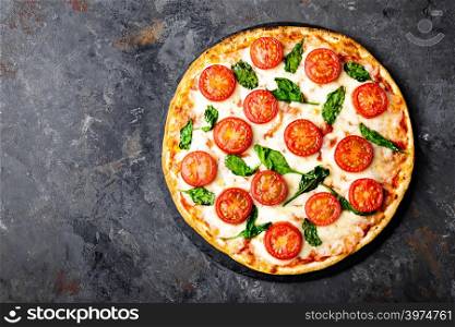 Pizza Margherita with mozzarella cheese, basil and tomatoes Traditional italian food. Classic recipe. Top view
