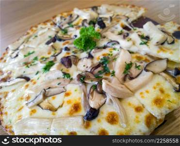 Pizza mushroom and cheese on a wooden board