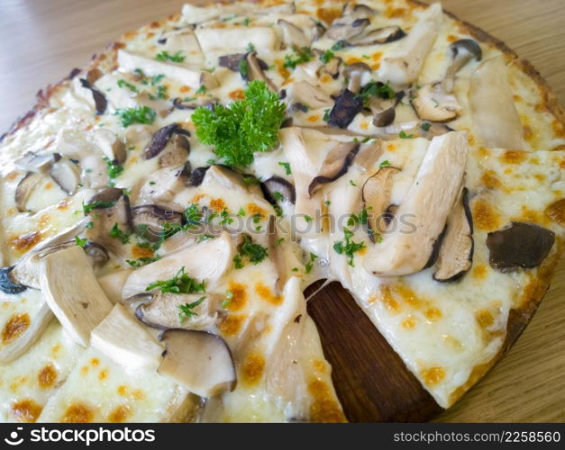 Pizza mushroom and cheese on a wooden board