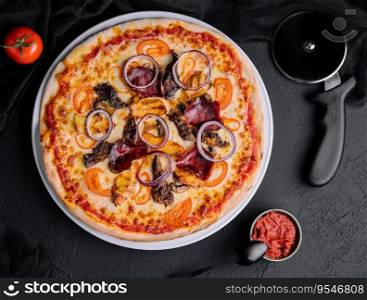 pizza on cutting board with cutter nearby, top view