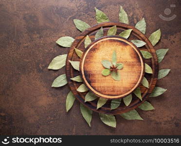 Pizza or bread cutting board and laurel leaf for homemade baking on table. Food recipe concept at stone or marble background texture with copy space. Flat lay of  panorama, panoramic top view