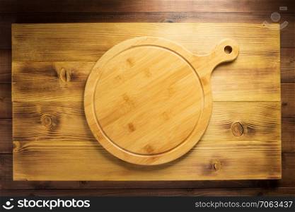 pizza or bread cutting board at wooden table, top view