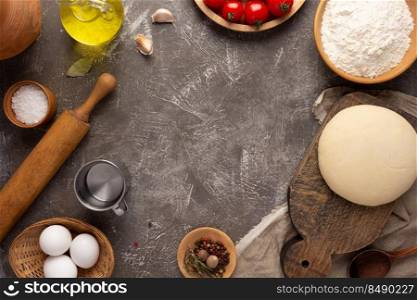 Pizza or dough for bread with ingredients at table. Pizza recipe homemade on tabletop background