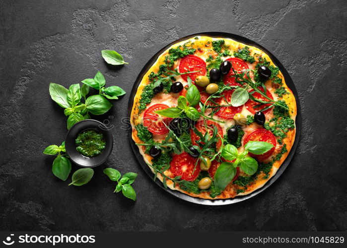 Pizza. Traditional italian pizza with green basil pesto sauce, top view