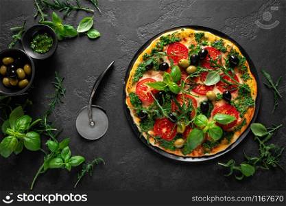 Pizza. Traditional italian pizza with green basil pesto sauce, top view