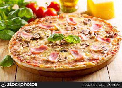 pizza with bacon and mushrooms on wooden table