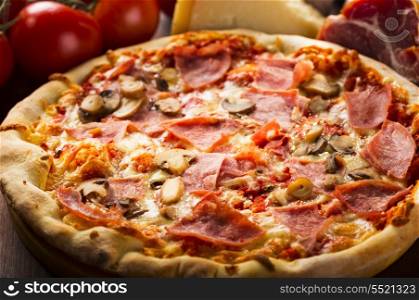 pizza with bacon, salami and vegetables