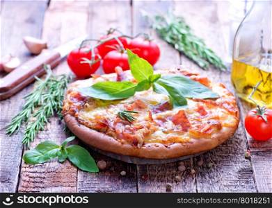 pizza with cheese and ham on a table