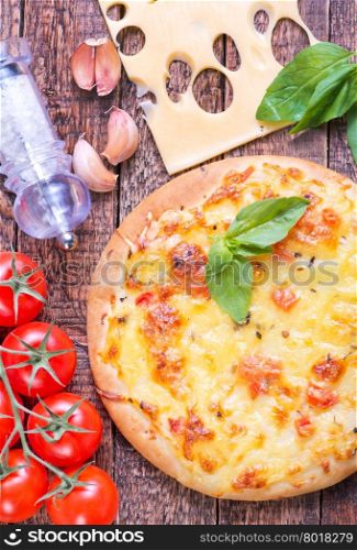 pizza with cheese on the wooden table