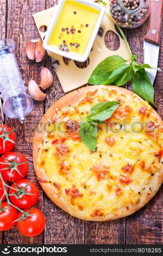 pizza with cheese on the wooden table