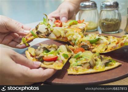 Pizza with colorful vegetable topping ready to be eaten