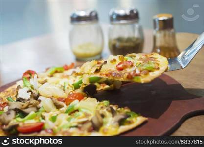 Pizza with colorful vegetable topping ready to be eaten