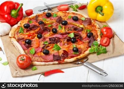 Pizza with different ingredients on wooden table