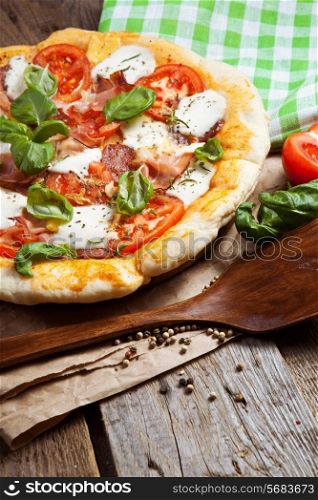 Pizza with dry cured ham and basil