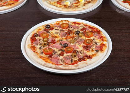 pizza with ham and mushrooms at the table