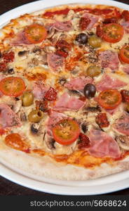 pizza with ham and mushrooms at the table