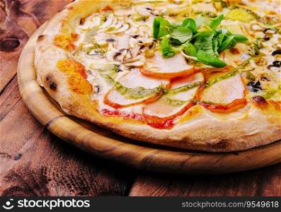 Pizza with ham and mushrooms on a wooden board
