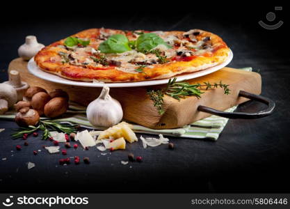 Pizza with Ham and Mushrooms on dark background