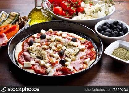 pizza with ham,pepper,zucchini and black olives ingredients