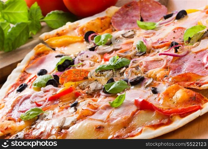 pizza with ham, salami and vegetables