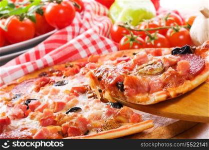 pizza with ham, salami and vegetables