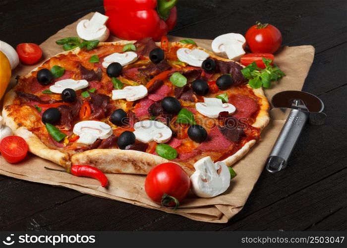 Pizza with ingredients on wooden table