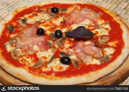 pizza with mushrooms, olives and ham