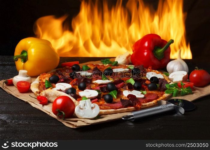 Pizza with oven fire on background