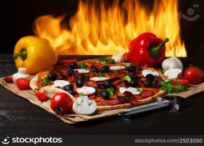 Pizza with oven fire on background