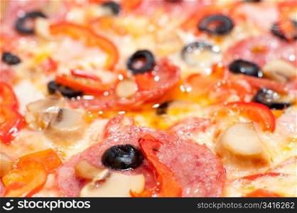 pizza with peperoni, champignons and olives, macro