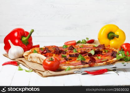 Pizza with salami and ham and cheese on wooden table
