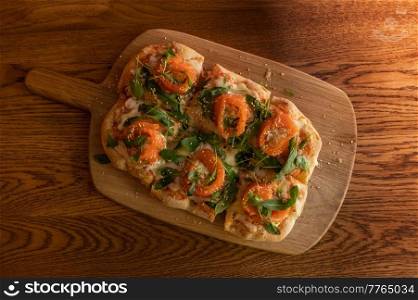 Pizza with salmon on roman dough with ruccola. Roman Pizza with salmon