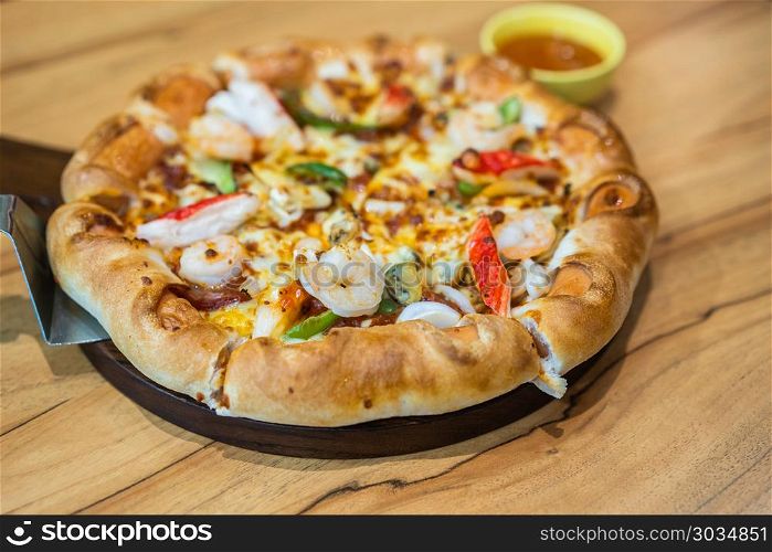 pizza with seafood. pizza with seafood on wood table