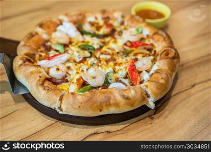 pizza with seafood. pizza with seafood on wood table