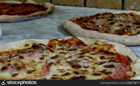 pizza with tomato , mozzarella , ham, mushrooms and eggs