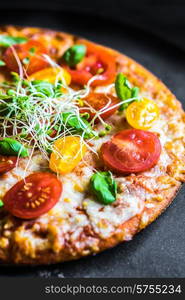 Pizza with tomatoes and basil