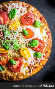 Pizza with tomatoes and basil