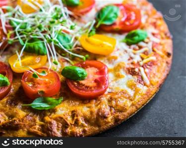 Pizza with tomatoes and basil