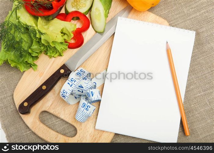 Place for cooking vegetables, vegetables, and a notebook. symbol of a healthy lifestyle.