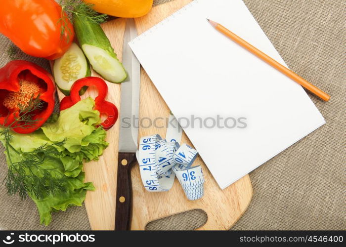 Place for cooking vegetables, vegetables, and a notebook. symbol of a healthy lifestyle.