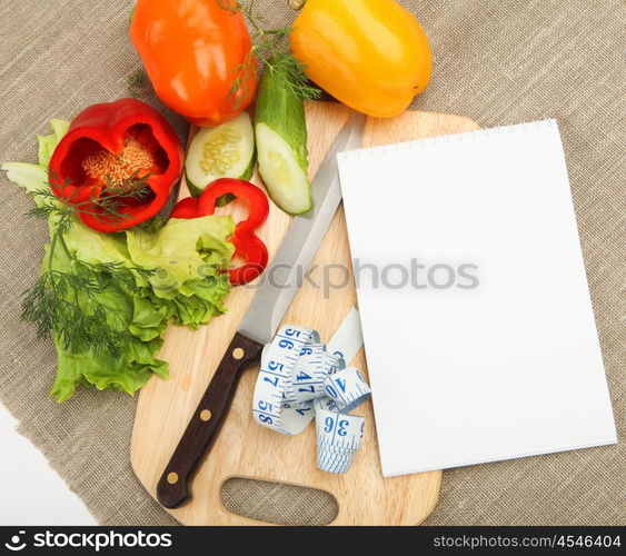 Place for cooking vegetables, vegetables, and a notebook. symbol of a healthy lifestyle.