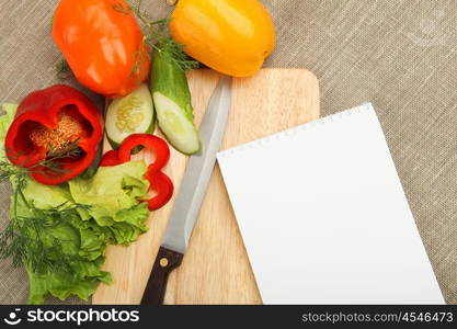 Place for cooking vegetables, vegetables, and a notebook. symbol of a healthy lifestyle.