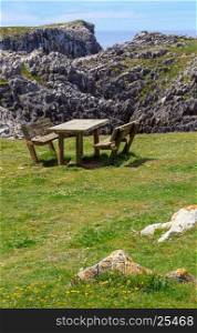Place of rest (table with benches) on summer blossoming coast near Camango, Asturias (Spain).