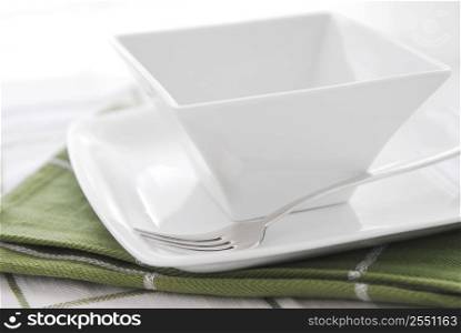 Place setting of white plate and bowl