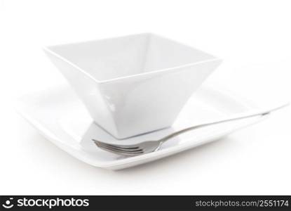 Place setting of white plate and bowl isolated on white background