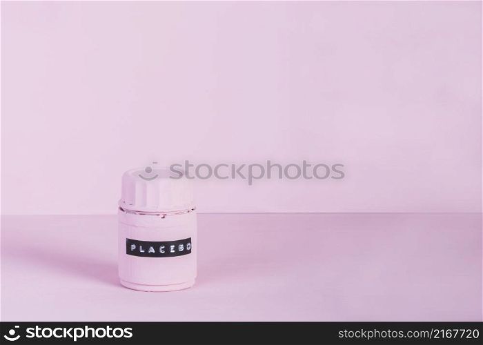 placebo bottle with label against pink background