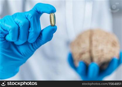 Placebo Effect Concept. Female doctor holding model of brain and placebo supplement pill, explaining the placebo effect healing phenomenon. Placebo Effect Concept