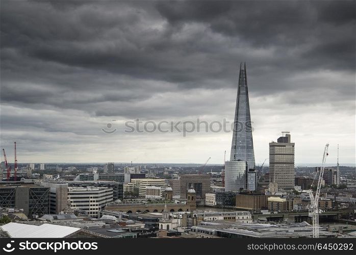 Places. London cityscape skyline with iconic landmark buildings in The City with dramatic stormy sky