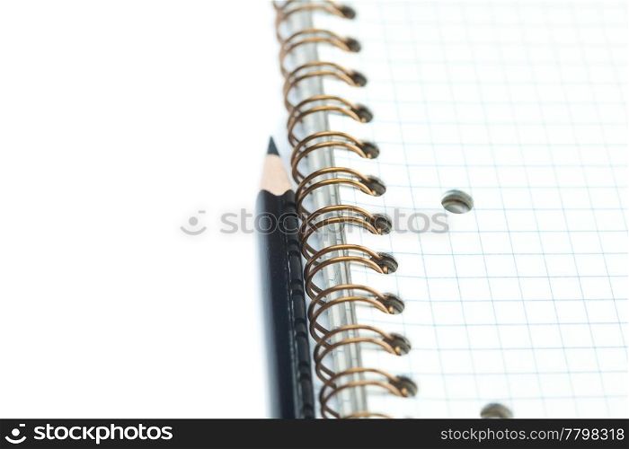 plaid notebook with a spiral and pencil